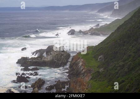 View along the coastline of were the Tsitsikamma Mountains meets the southern Indian Ocean, along the southern coast of South Africa. Photographed in Stock Photo