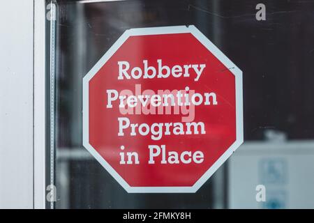 View of sign on the window Robbery Prevention Program in Place in Courtenay, Canada Stock Photo