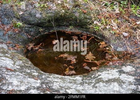 Hiidenkirnu or giant's cauldron or giant's kettle or moulin pothole or glacial pothole in Seurasaari Island, Helsinki, Finland Stock Photo