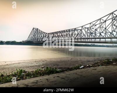 KOLKATA, INDIA - May 10, 2021: Howrah bridge - The historic cantilever bridge on the river Hooghly with twilight sky. Howrah bridge is considered as t Stock Photo