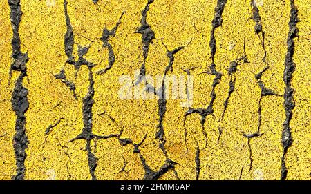 macro zoom closeup of yellow road street stripe on asphalt shot as an overhead industrial scene Stock Photo