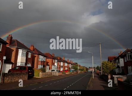 Loughborough, Leicestershire, UK. 10th May 2021. UK weather. A rainbow forms over a street of 1930Õs houses after rainfall. Credit Darren Staples/Alamy Live News. Stock Photo