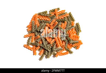 red and green tomato spinach flavored curly pasta noodles gourmet exotic organic food on a clear white table scene Stock Photo