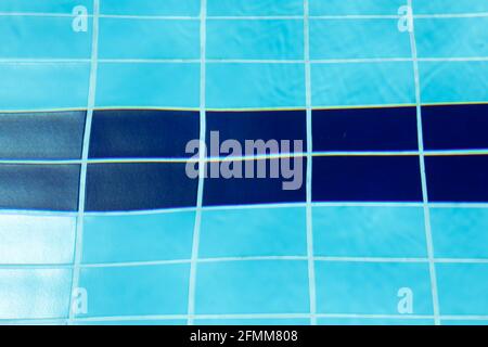 Ripples and reflections in the crystal clear blue water between the lanes of a swimming pool in the municipality of Gallur, Aragon, Spain, on a summer Stock Photo