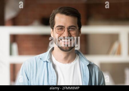 Head shot portrait confident smiling bearded businessman in glasses Stock Photo