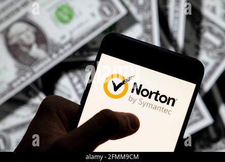 China. 21st Apr, 2021. In this photo illustration the cybersecurity and anti-virus malware software developed by Symantec Corporation, Norton Anti-virus logo seen displayed on a smartphone with USD (United States dollar) currency in the background. Credit: Budrul Chukrut/SOPA Images/ZUMA Wire/Ģ����ý Live News Stock Photo