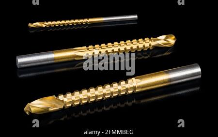 Drill bits set with sharp edges. Serrations for horizontally drilling after creating hole. Steel cutting tools, Gold titanium coating, cylindric shank. Stock Photo