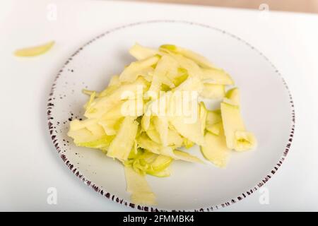 Apple chips. Thin slices of apple slices on the plate. Ingredients for apple pie, strudel. Stock Photo
