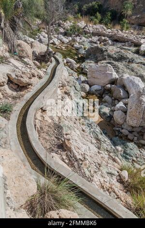 Falaj water channel in Wadi Tiwi valley, Oman Stock Photo