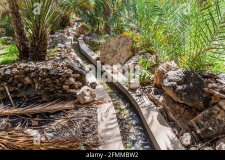 Traditional irrigation canal called Falaj in Wadi Tiwi valley, Oman Stock Photo