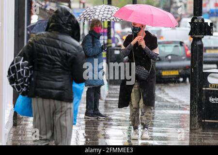 London, UK. 5th May, 2021. People shelter from rain beneath umbrellas in London. Credit: Dinendra Haria/SOPA Images/ZUMA Wire/Alamy Live News Stock Photo