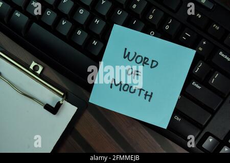 Word Of Mouth write on sticky notes isolated on Wooden Table. Stock Photo
