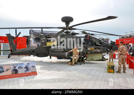 British Army AgustaWestland WAH-64 Apache gunship on display at Farnborough International Airshow. Weapons. Defence industry. Military personnel, crew Stock Photo