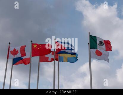 Various national flags countries under a blue sky Stock Photo - Alamy