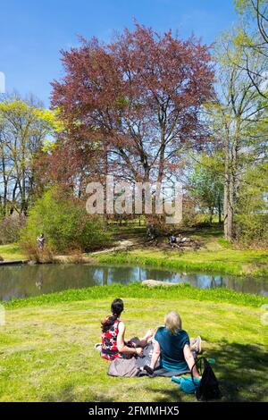 Two women resting in the spring park, enjoying nice weather, lifestyle Well Being Stock Photo