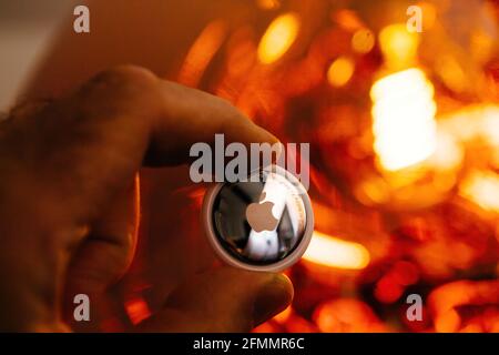 Man pov looking at AirTag with rear engraved text Stock Photo