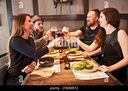 Friends having a good time at hipster bar in Reykjavik Stock Photo