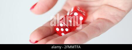 On hand are red dice with white marks Stock Photo