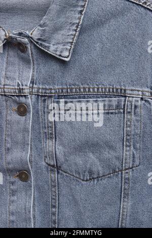 Close up of the front of a denim jacket. Close-up denim jacket pocket. Denim jacket background. Blue denim texture for background. Stock Photo