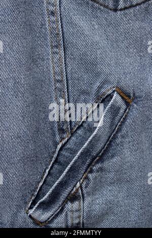 Close-up denim jacket pocket. Denim jacket background. Blue jeans texture for background. Close-up blue denim texture. Texture of blue jeans as backgr Stock Photo