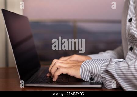 Close up of hands man working at home in the living room Stock Photo