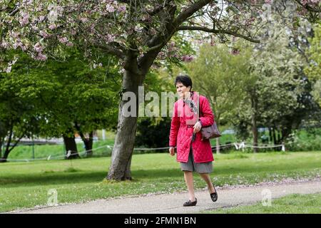 London, UK. 09th May, 2021. A woman walks in a park on a warm sunny day in London. (Photo by Dinendra Haria/SOPA Images/Sipa USA) Credit: Sipa USA/Alamy Live News Stock Photo