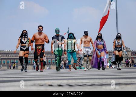 Mexico, Mexico. 10th May, 2021. Mexican Luchadores walk on Madero Street. 'The Brigade two of three falls' called by the Mexican City Youth Institute made a round of Madero Street in the Historic Center encouraging the use of face masks since the pandemic still continues despite the epidemiological yellow traffic light. (Photo by Guillermo Diaz/SOPA Images/Sipa USA) Credit: Sipa USA/Alamy Live News Stock Photo