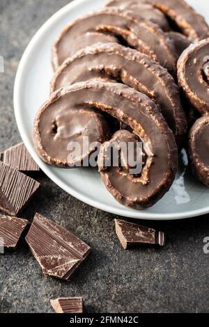 Sweet pastry palmeritas with chocolate icing on plate. Stock Photo
