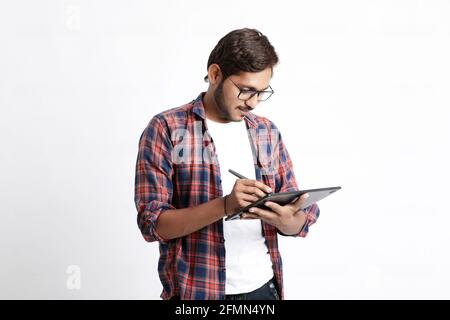 Indian Professional designer using graphic tablet connected to smartphone with digital pen. Stock Photo