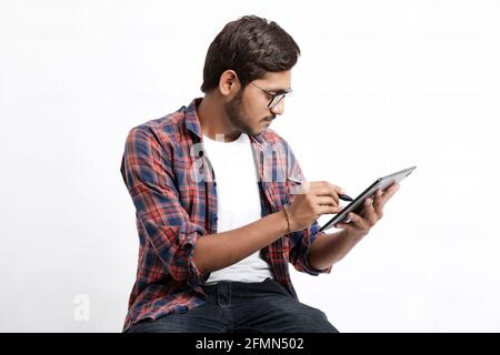 Indian Professional designer using graphic tablet connected to smartphone with digital pen. Stock Photo