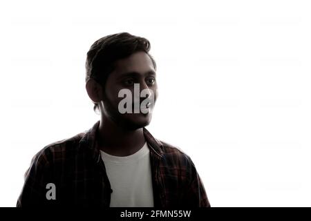 Young Indian man standing on white background. Stock Photo