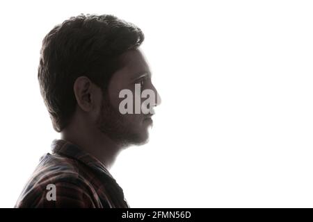 Young Indian man standing on white background. Stock Photo