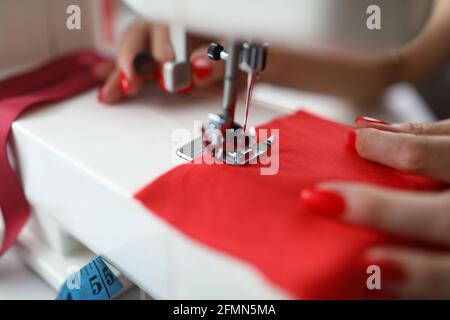 Close-up of dressmaker lady working on sewing machine Stock Photo