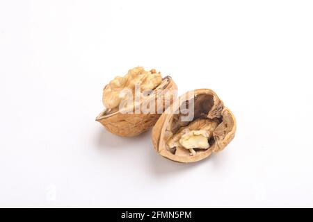 Walnuts and cracked walnut, isolated on white background Stock Photo