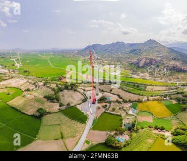 Wind turbine being repaired, assisted by crane and elevator. Wind power plant. green meadow with Wind turbines generating electricity Stock Photo