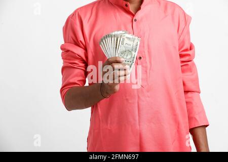 Indian man counting newly launched indian five hundred rupees. Money counting background business concept on white background