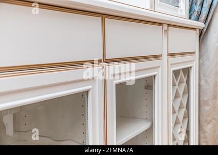 Classical style white showcase with glass doors and gilding extreme closeup view Stock Photo