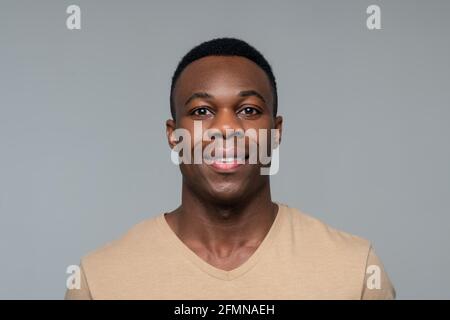 Dark skinned man looking in good mood Stock Photo