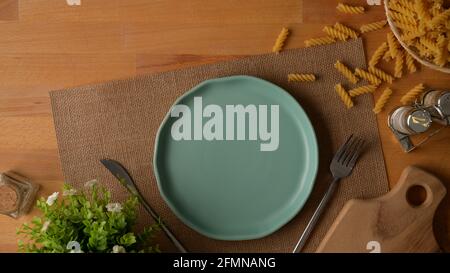 Download Top View Of Dinning Table With Mock Up Turquoise Ceramic Plates And Silverware On Placemat And Napkin On White Table Stock Photo Alamy