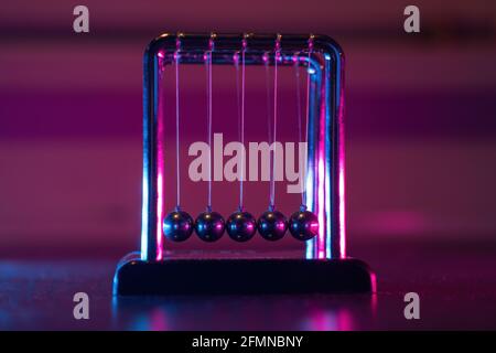 Newton cradle. Demonstrating gravity, action and reaction principle in physics. Stock Photo