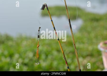 Close up of some fishing hooks hanging from the rod, selective focusing Stock Photo