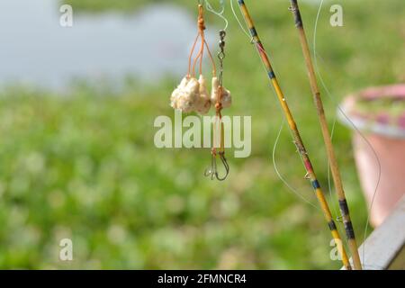 Close up of some fishing hooks hanging from the rod, selective focusing Stock Photo