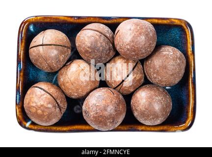 top view of sewn macadamia nuts in bowl cutout on white background Stock Photo