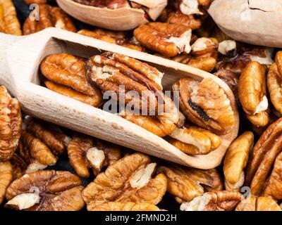 little wooden scoop in pecan nuts close up Stock Photo