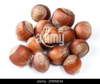 pile of shelled and unshelled hazelnuts closeup on white Stock Photo