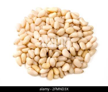handful of unpeeled pine nuts closeup on white background Stock Photo
