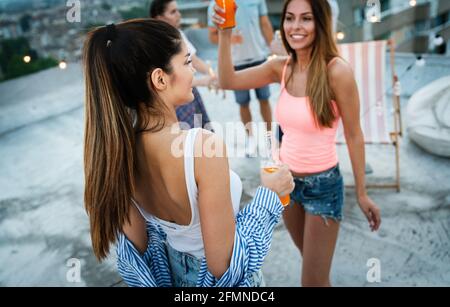 Party, holidays, celebration and friendship concept. Happy beautiful girls dancing and having fun Stock Photo