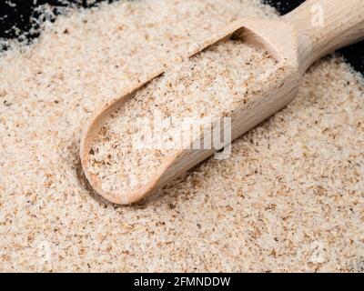 little wooden scoop in Psyllium husk close up Stock Photo