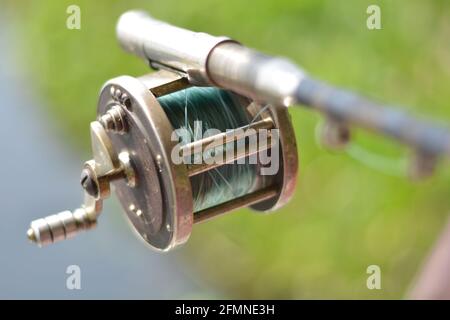 Close up of fishing rod wheel gear, selective focusing Stock Photo - Alamy