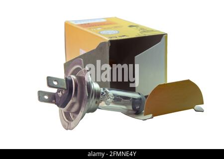 dual-contact halogen spare lamp for low beam car headlights, out from its cardboard packaging. isolated on white background Stock Photo